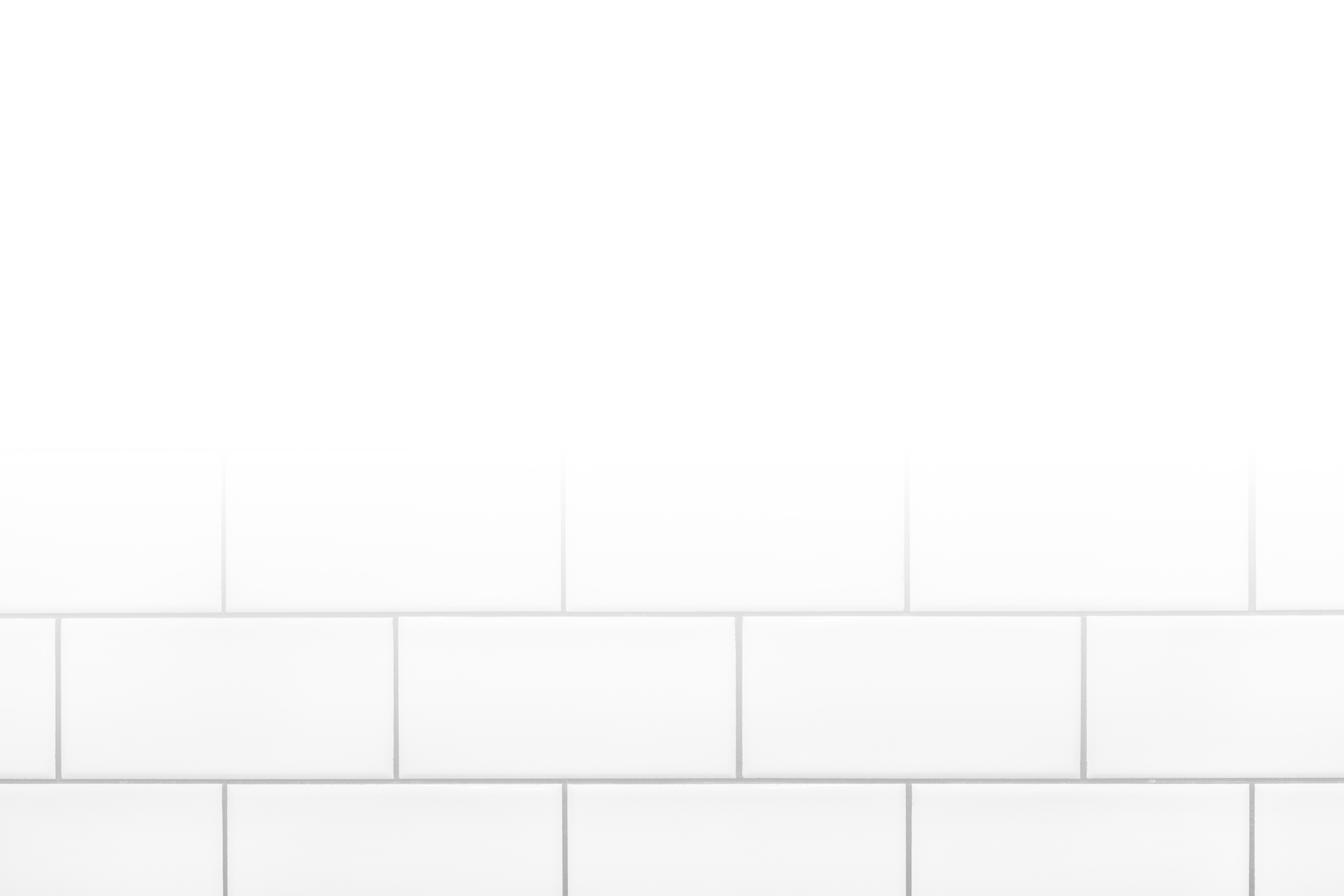 A plain white tile wall with a simple, minimalist design, emphasizing clean and modern aesthetics. No landmarks or historical buildings are visible.